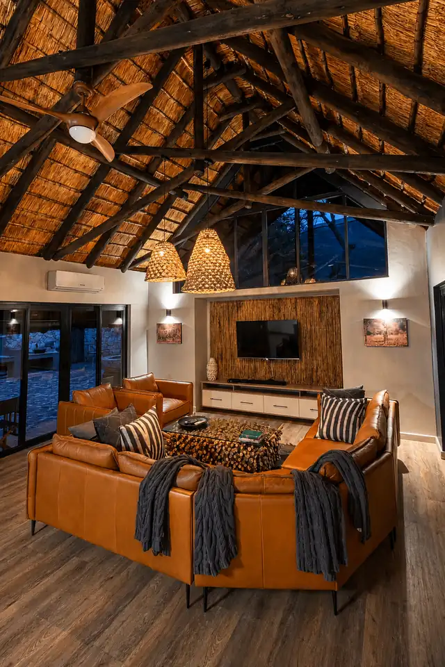 Detail of the lounge - soft textures, warm wood, soaring thatch.