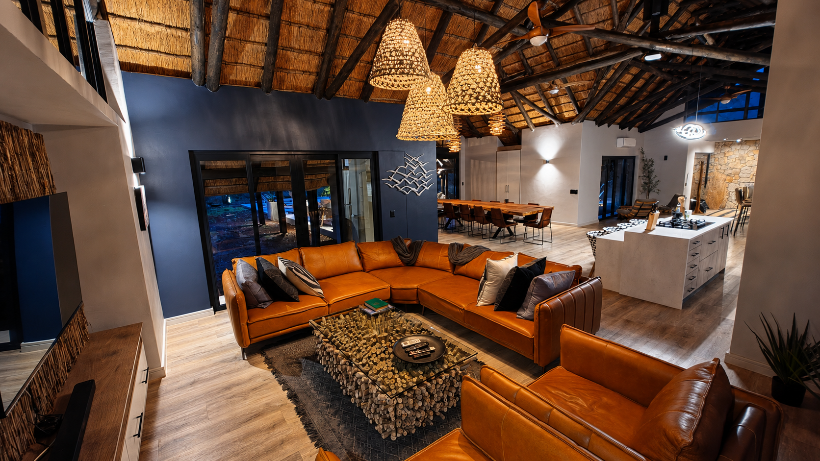 The open lounge under high thatch, with panoramic bush views.