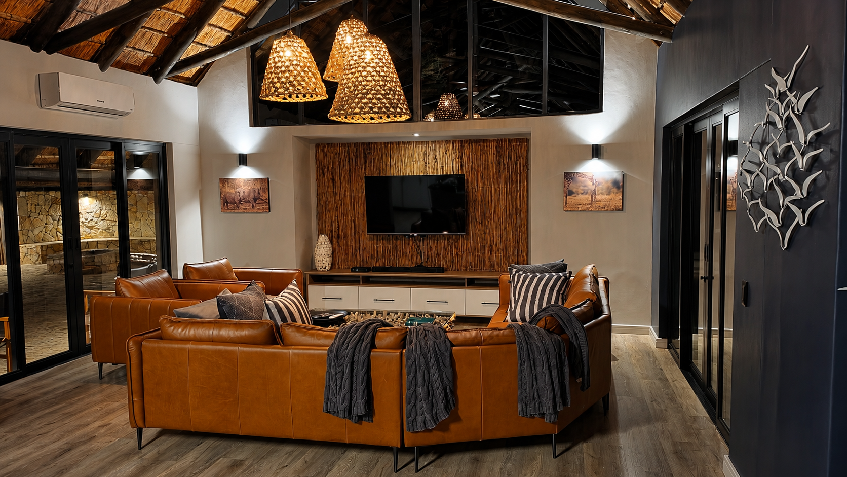 Comfortable sofas facing the floor-to-ceiling glass onto the reserve.