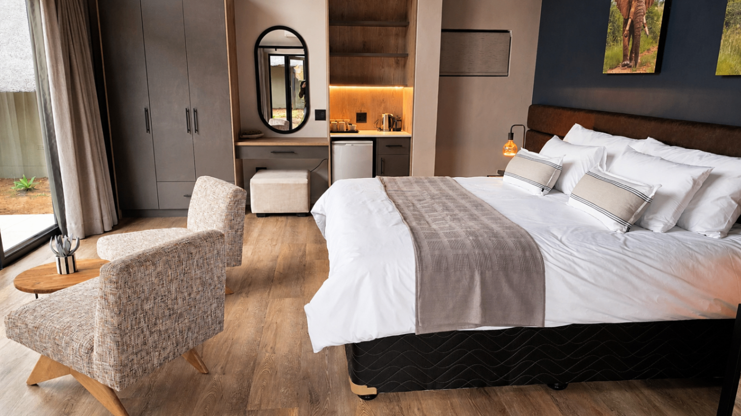 Main chalet bedroom - king bed with full-height glass onto the bush.