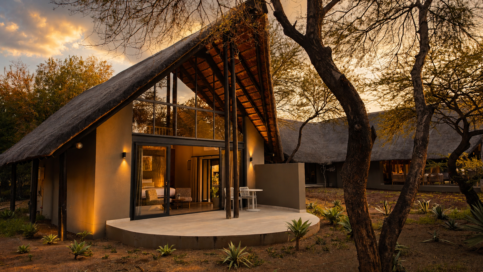 A standalone chalet at golden hour, framed by the bushveld.
