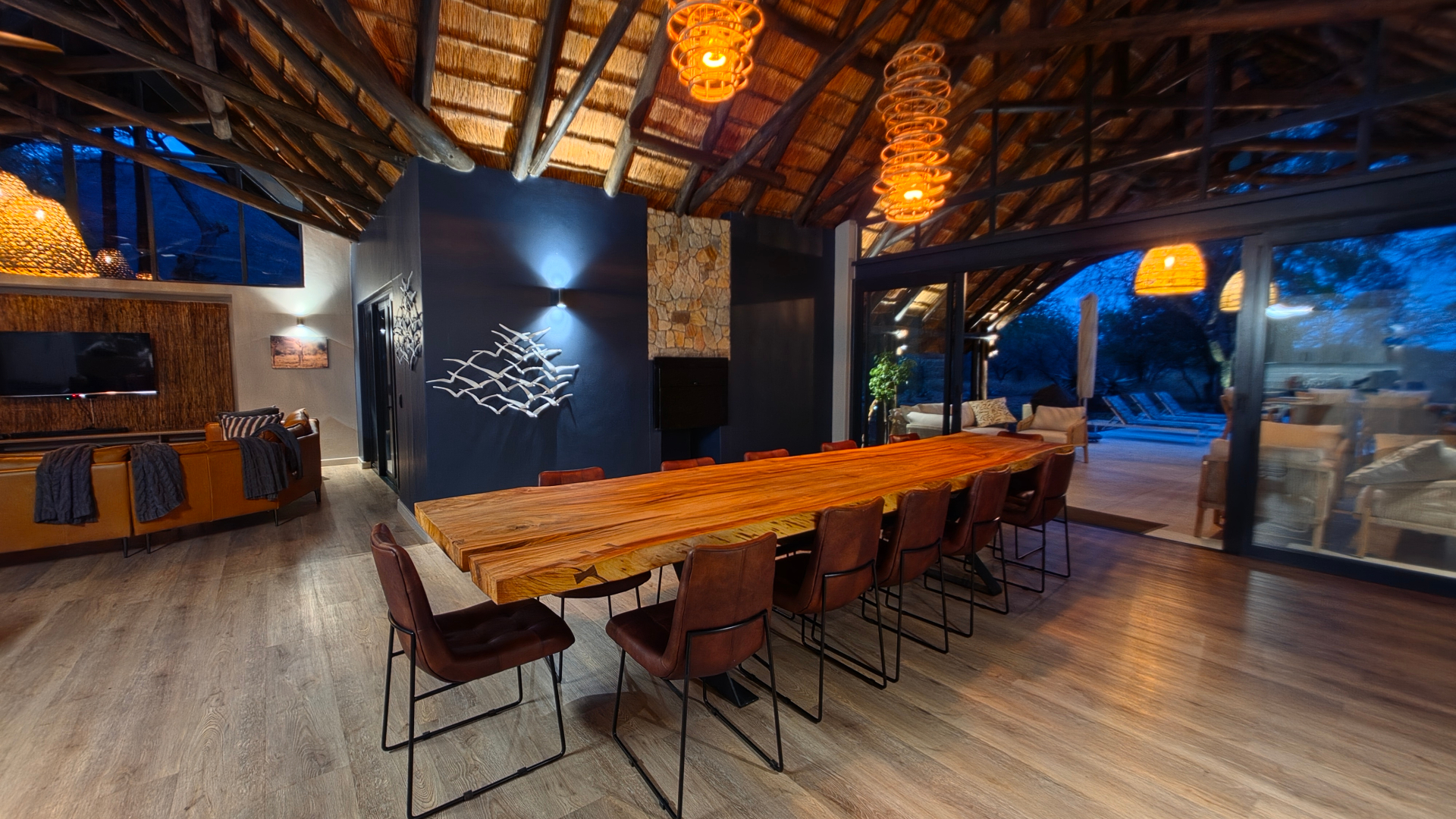 Dining table set for the evening, opening onto the patio and pool.